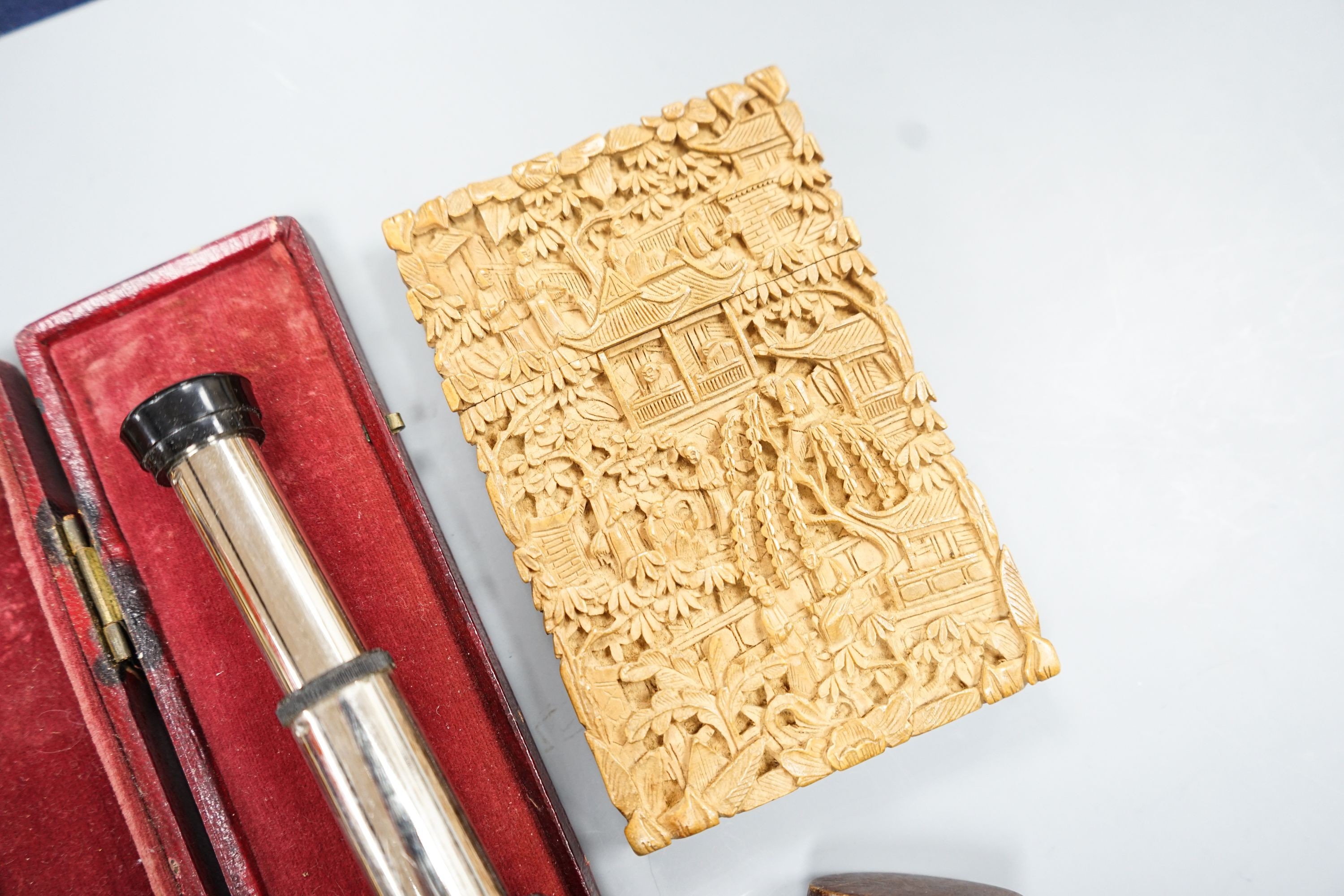 A Chinese carved sandalwood card case, a cased set of Avery gold scales, a Zonex telescope, a cased Cary prismatic instrument and a floral carved wood box.